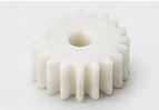 Illustrative polymer gear with a central bore — AI-generated illustration, not a vetcnc photograph